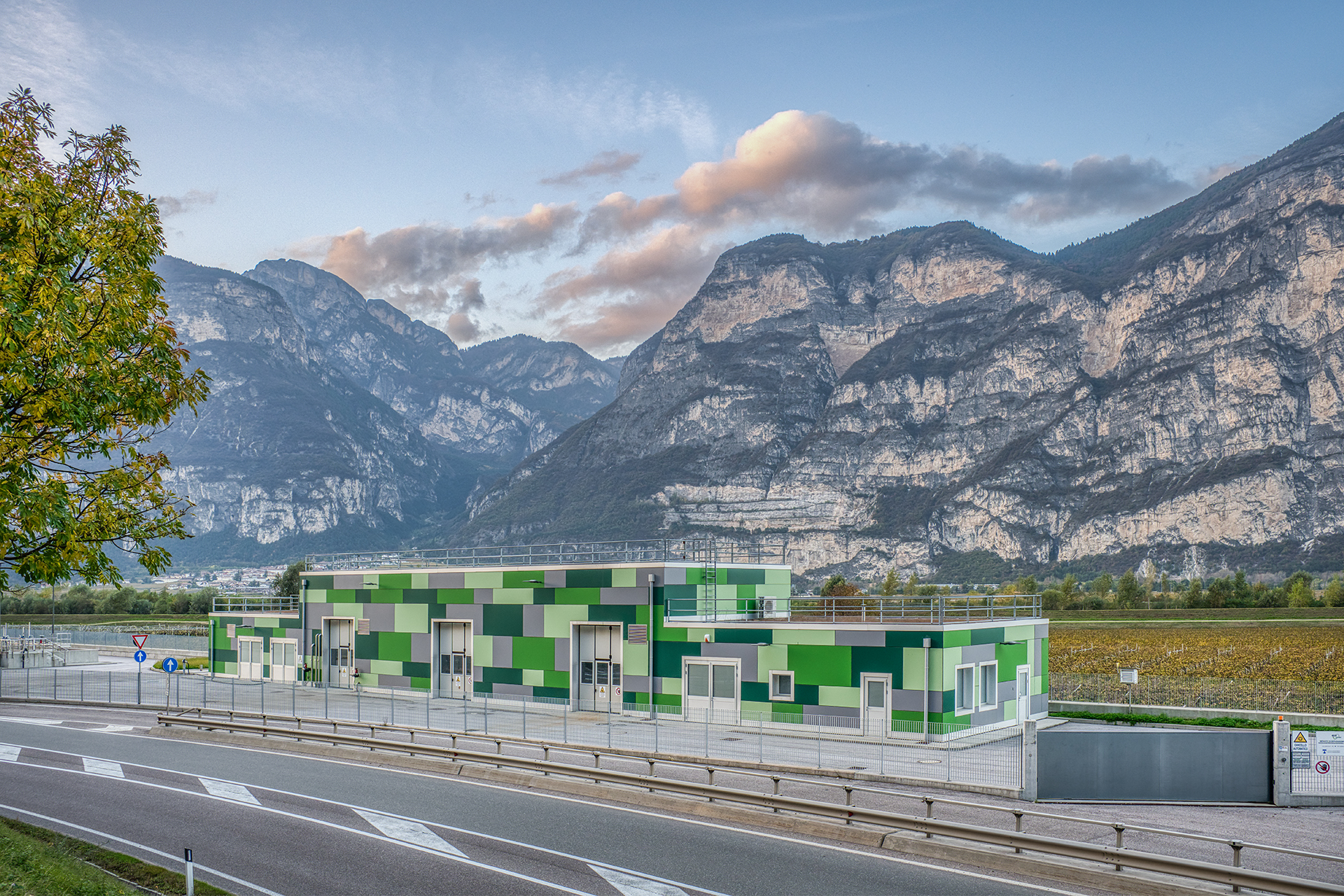 Moderno depuratore Eco Center a Salorno con pareti verdi, armoniosamente integrato nel paesaggio montano